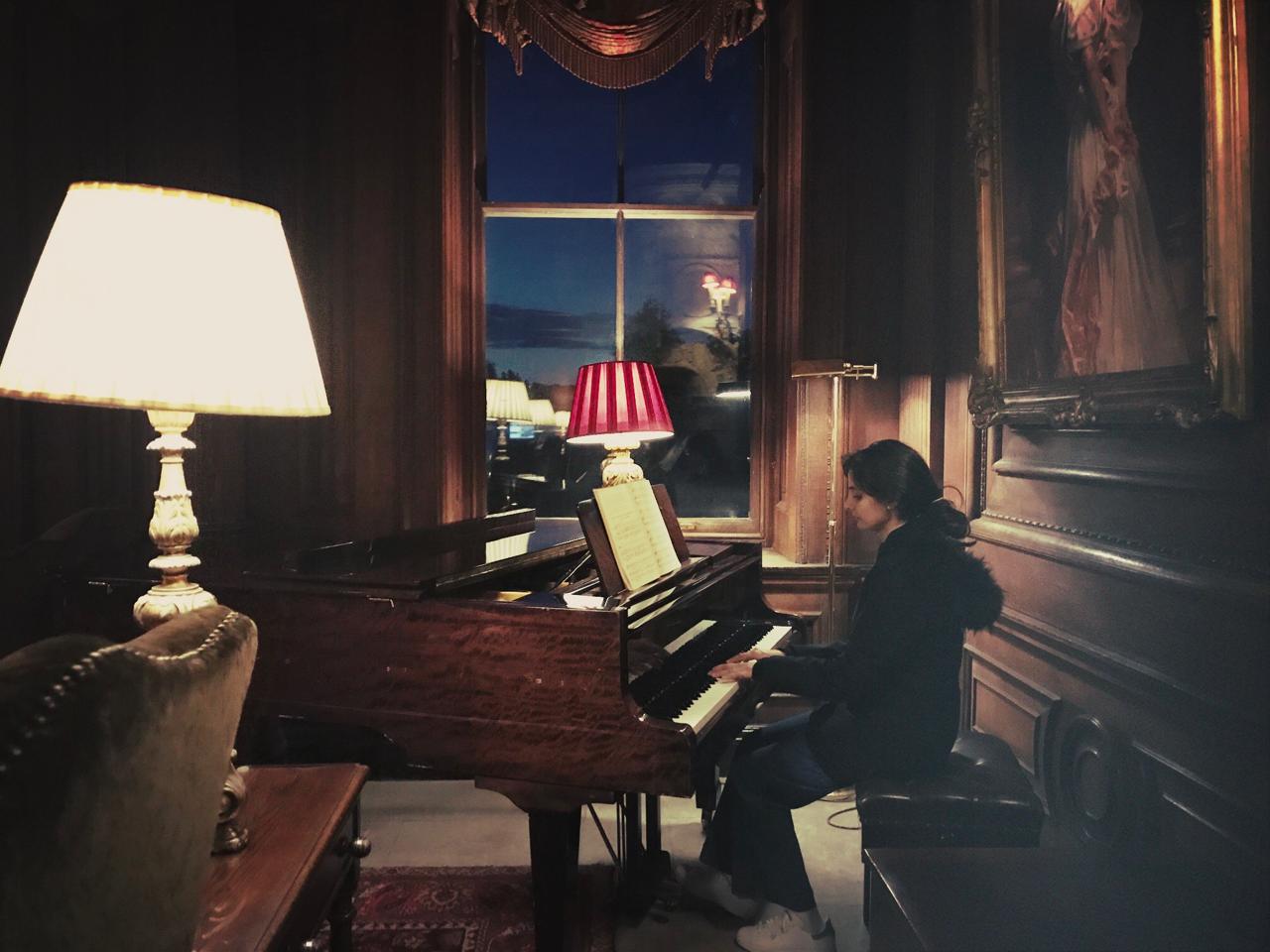 Naina playing a grand piano